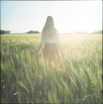 Woman in sunlit field